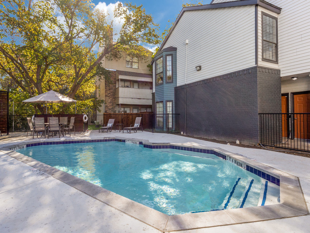 a pool in front of a house with a patio at The  Laney
